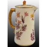 A Royal Worcester blush ivory coffee pot, gilt handles and painted floral decoration on apricot