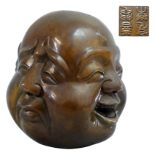 A Chinese bonze four faced Buddha head, with seal mark to the base, height 12 cm.