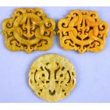 A pair of Chinese sand coloured jade panels, with pierced and engraved dragon decoration, 7 x 6 cm