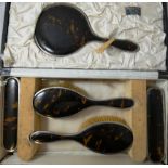 A silver and tortoise shell six piece dressing table set, London 1923, comprising; hand mirror,