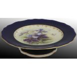 A Royal Worcester blush ivory fruit plate, signed R. Sebright, with blue orchid motif on an