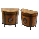 A pair of George III style satinwood and polychrome painted D shape commodes, the top with a band of