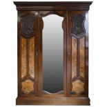 A Victorian mahogany triple wardrobe, the central bevelled mirror door flanked by panelled doors