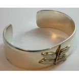 A silver bangle with an applied dragonfly, the inside stamped c.1997, Tiffany & C0., 925, width 21