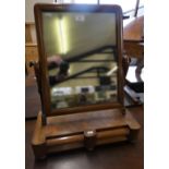 A Victorian mahogany swing mirror with two frieze drawers