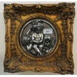 A cast metal relief of three cherubs, gilt frame