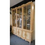 A very large limed beech display cabinet with three glazed doors over three cupboards, 224 x 48 x
