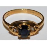 An 18ct gold sapphire and diamond three stone ring, 2 gms