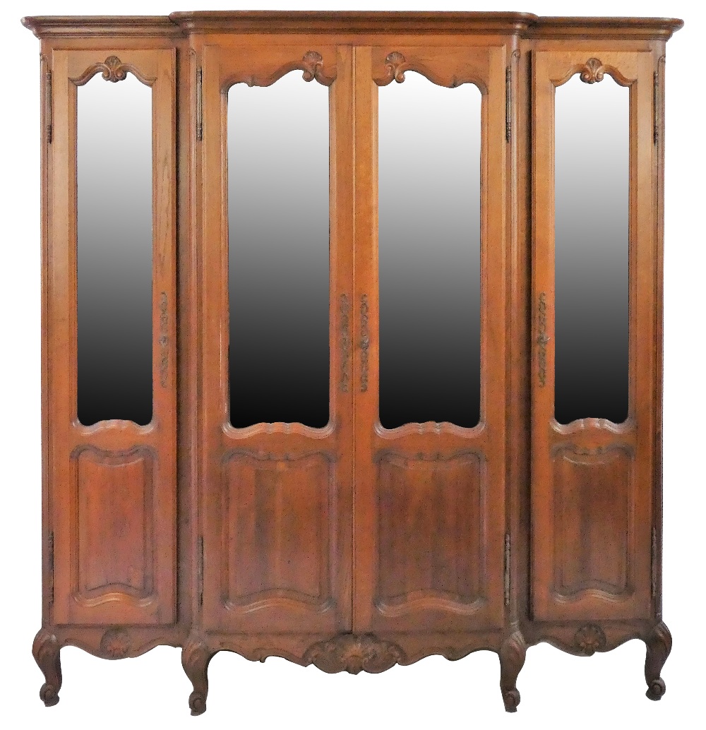 A 19th century French oak breakfront bookcase, the shaped part glazed doors with carved mouldings,
