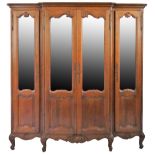 A 19th century French oak breakfront bookcase, the shaped part glazed doors with carved mouldings,