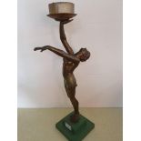 An Art Deco cold painted spelter figurine lamp, with arms outstretched, lacking globe, height 51 cm