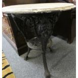 A Victorian cast iron pub table by Gaskell & Chambers Ltd, Briggate, Leeds with mask heads and