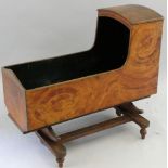 A 19th century painted pine cradle, with canopy and sleigh rockers, the interior painted green,
