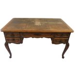 An early 20th century French parquetry-topped oak desk, with central frieze drawer, flanked by a
