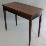 A 19th century mahogany fold over side table, with boxwood edges, single swing leg, raised on