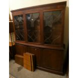 A mahogany astragal glazed bow front display cabinet over three cupboard doors