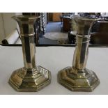 A pair of Edwardian silver candlesticks, Birmingham 1909, of octagonal form, loaded