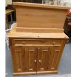 A pine T.V. cabinet with drop drawer for DVD player above two cupboard doors, 95 x 80 x 89 cm and