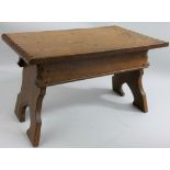 Jack Grimble, Cromer - an adzed oak stool, with rectangular top, the legs with arched supports,