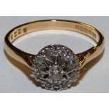 An 18ct gold diamond cluster ring, claw set with brilliant and single cut stones