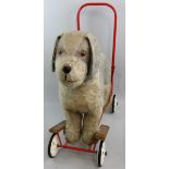 A Tri-ang (Lines Bros) push-along dog on wheels, with grey and white mohair, brown eyes, red steel