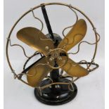 A vintage electric desk fan, with brass oscillating blades and guard, No. 3227875.