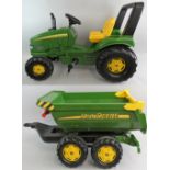 A Rolly Toys 'John Deere' child's ride-on pedal powered tractor with trailer, in green and yellow