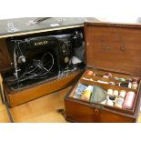 A mahogany sewing box and contents, together with a cased electric Singer sewing machine (2)