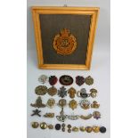 A wooden relief plaque depicting a Queen's crown cap badge of the Royal Engineers, together with a