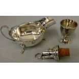 A silver sauceboat, Sheffield 1936 with wavy boarder, a silver egg cup, Birmingham 1914 and a silver