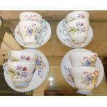 A set of eight wild flowers patterned cup and saucers