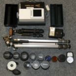 A collection of camera and photographic equipment including lenses, filters, flash, slide