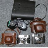 A pair of cased Chinon 10 x 50 binoculars, together with a camera and a white launder camera (3)