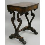 A mahogany side table, the hinged rectangular top opening to reveal a compartment, to carved