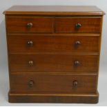 A Victorian mahogany chest of drawers, composed of two short over three long drawers, bun handles,