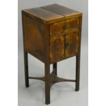 A Georgian mahogany night stand, the hinged lid opening to reveal three wells over a pair of
