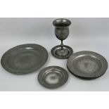 A Victorian pewter goblet, together with eight pewter plates, some with touch marks (9).