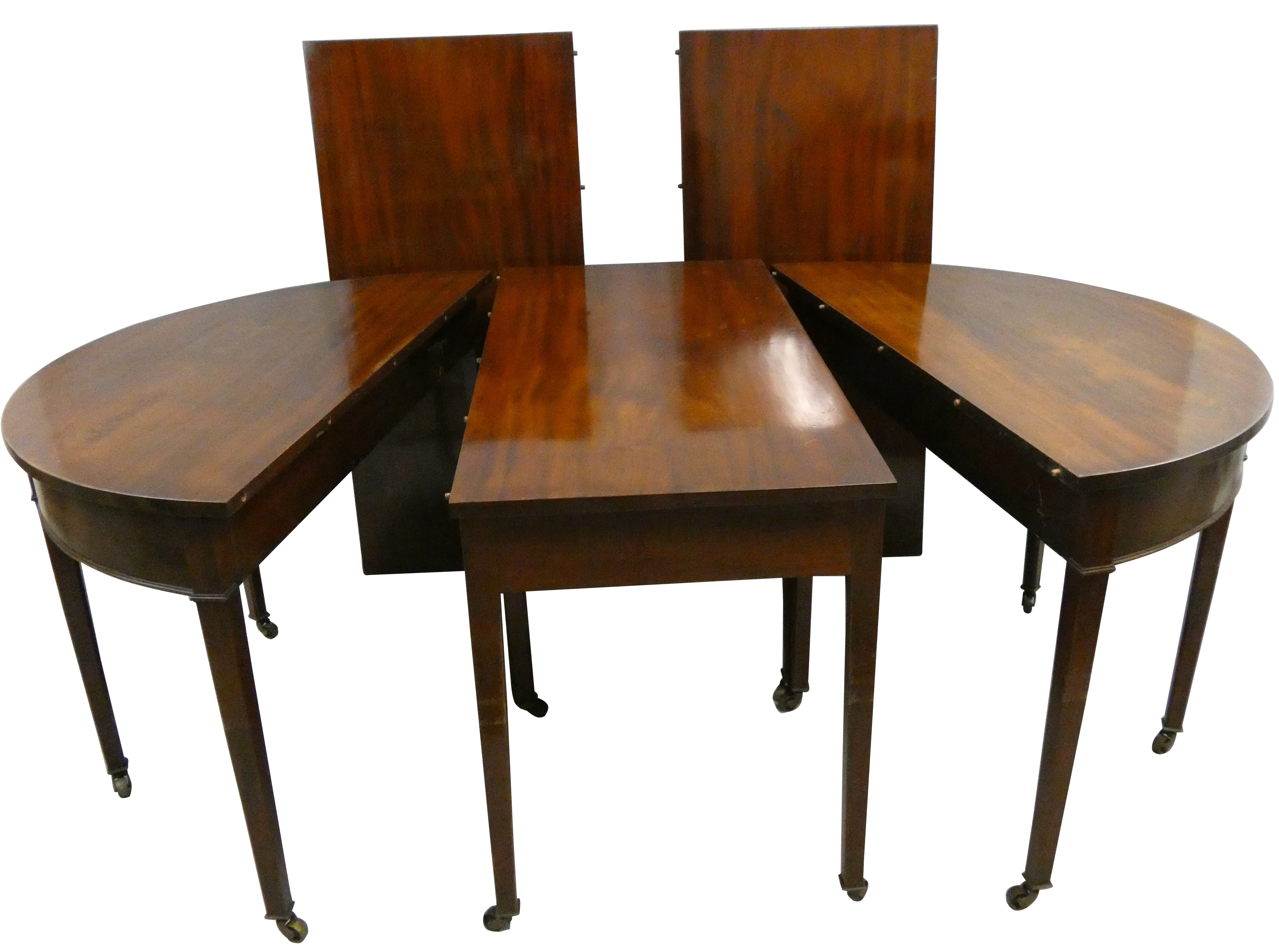 A George III mahogany D end dining table, in five sections, comprising two D ends with plain