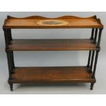 An Edwardian mahogany and pine three tier open bookcase, the top section with painted shell motif,