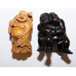 A Japanese carved hardwood netsuke, in the form of Sumo wrestlers, inset signature, height 5 cm