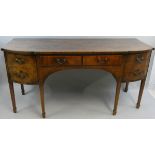 A George III mahogany bow and breakfront sideboard, the top with boxwood banding above a pair of