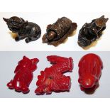 A Japanese carved red coral rabbit figure, length 4.5 cm, two other carved red coral figures and