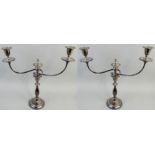 An electroplated pair of two branch, three light candelabra, the vase sconces with a gadrooned