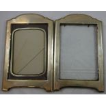 A silver matched pair of photograph frames, Birmingham 1915, of rectangular form with arched tops,