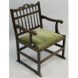 A 19th century mahogany armchair, with spindle back and drop in seat, the base with sleigh stretcher