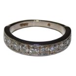 An 18ct white gold and diamond half eternity ring, stamped 18ct, channel set with ten brilliant