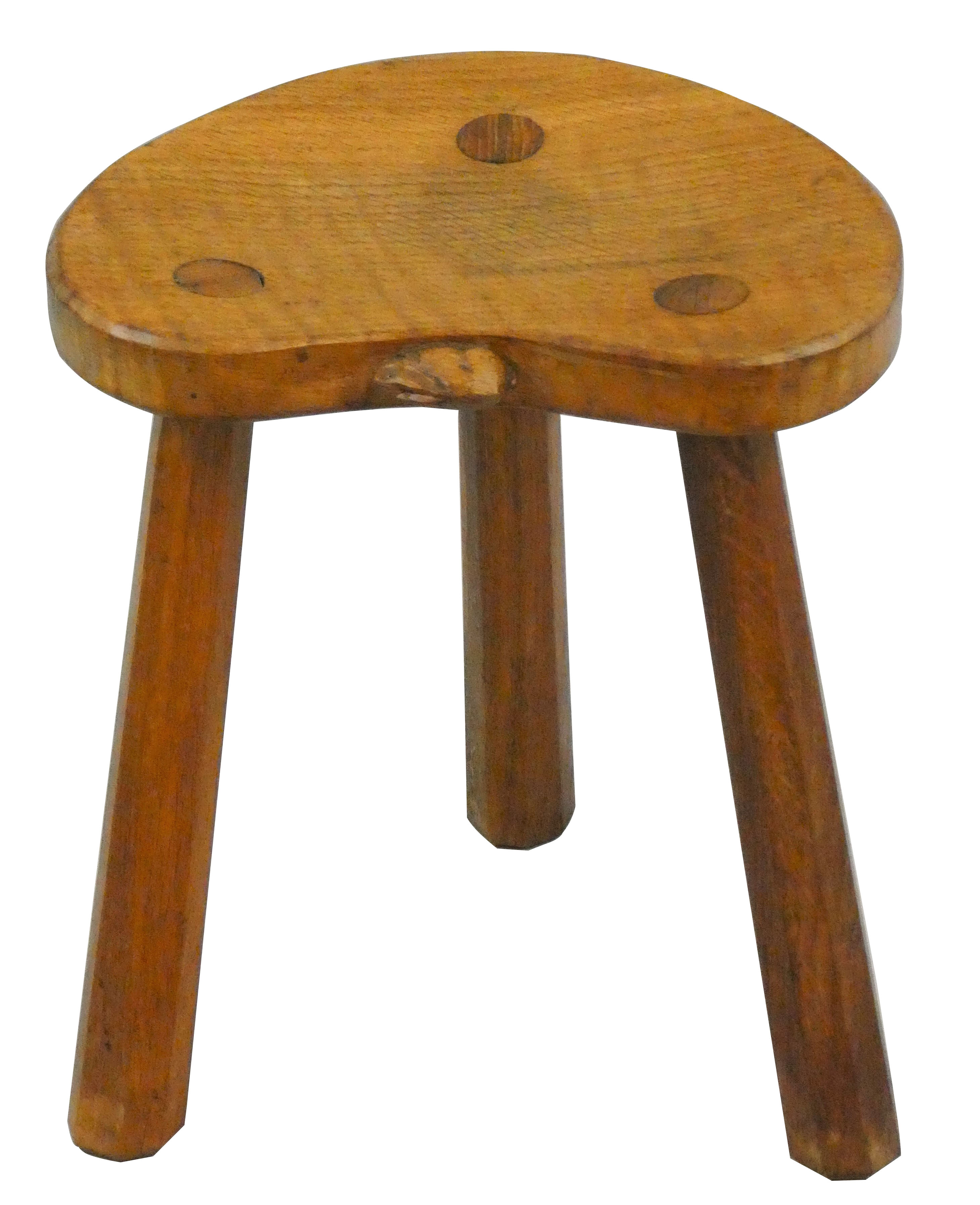 A Peter "Rabbitman" Heap of Wetwang oak three legged stool, shaped dished seat carved with Rabbit