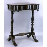 A Victorian mahogany work table, the shaped top opening to reveal a fitted interior with lidded