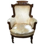 A Victorian mahogany framed armchair, with pierced and carved frame, gold velvet upholstered body,
