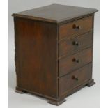 A Victorian mahogany miniature chest of four graduated long drawers, the top one imitating two short